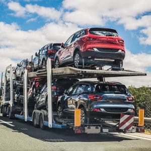 Car transporter moving on a road.